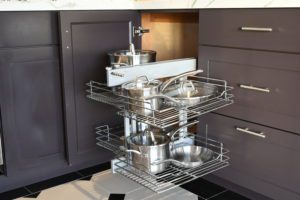A kitchen with two shelves and a sink