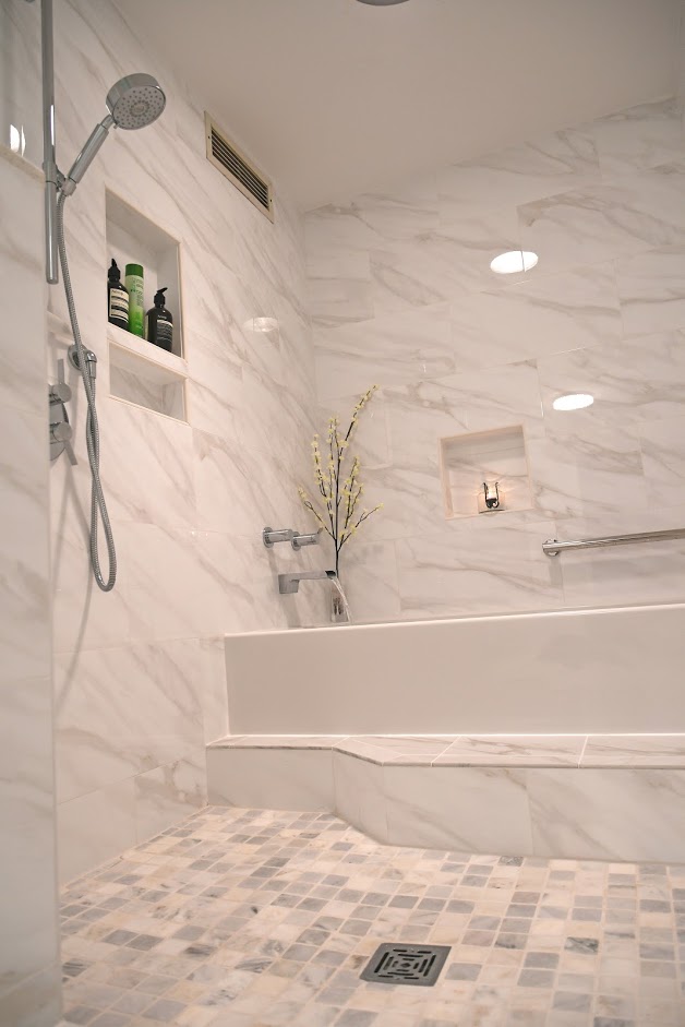 A bathroom with marble walls and floors