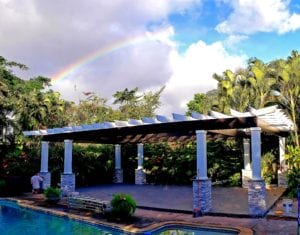 A rainbow over the pool and pergola.