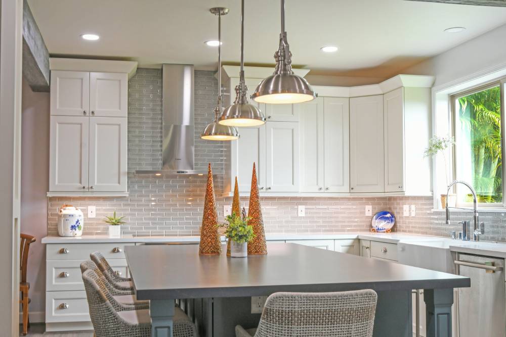 A kitchen with white cabinets and a table