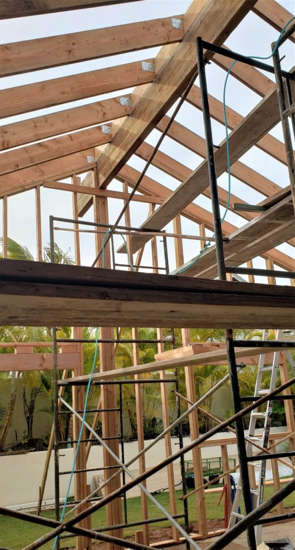 A building under construction with wooden beams and scaffolding.