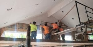 A group of men working on the stairs.