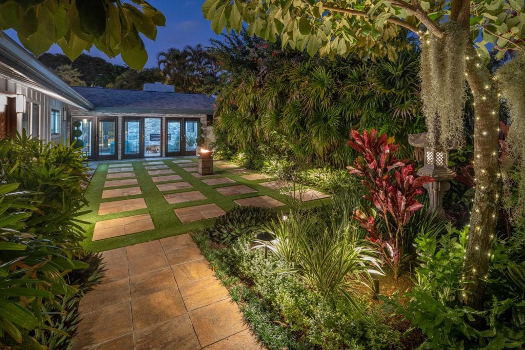 A garden with a pool and a walkway