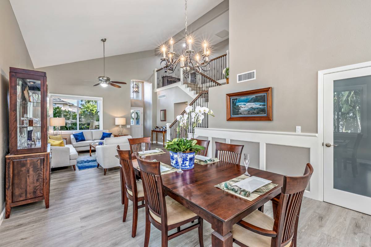 A dining room table with chairs and a fireplace.