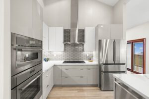 A kitchen with white cabinets and stainless steel appliances.