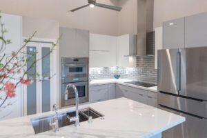 A kitchen with white cabinets and stainless steel appliances.