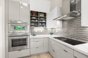 A kitchen with white cabinets and stainless steel appliances.