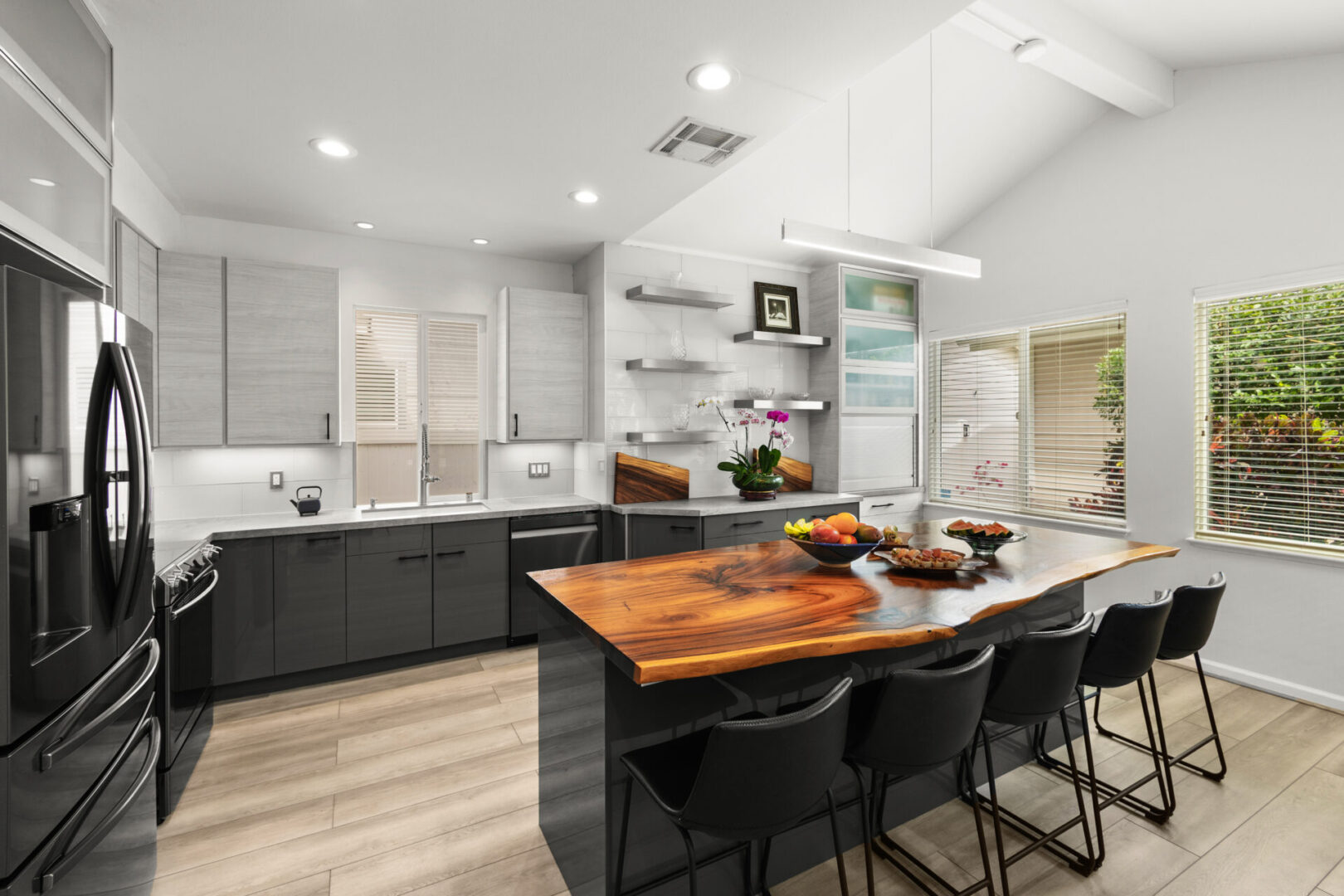 A kitchen with an island and wooden counter tops.