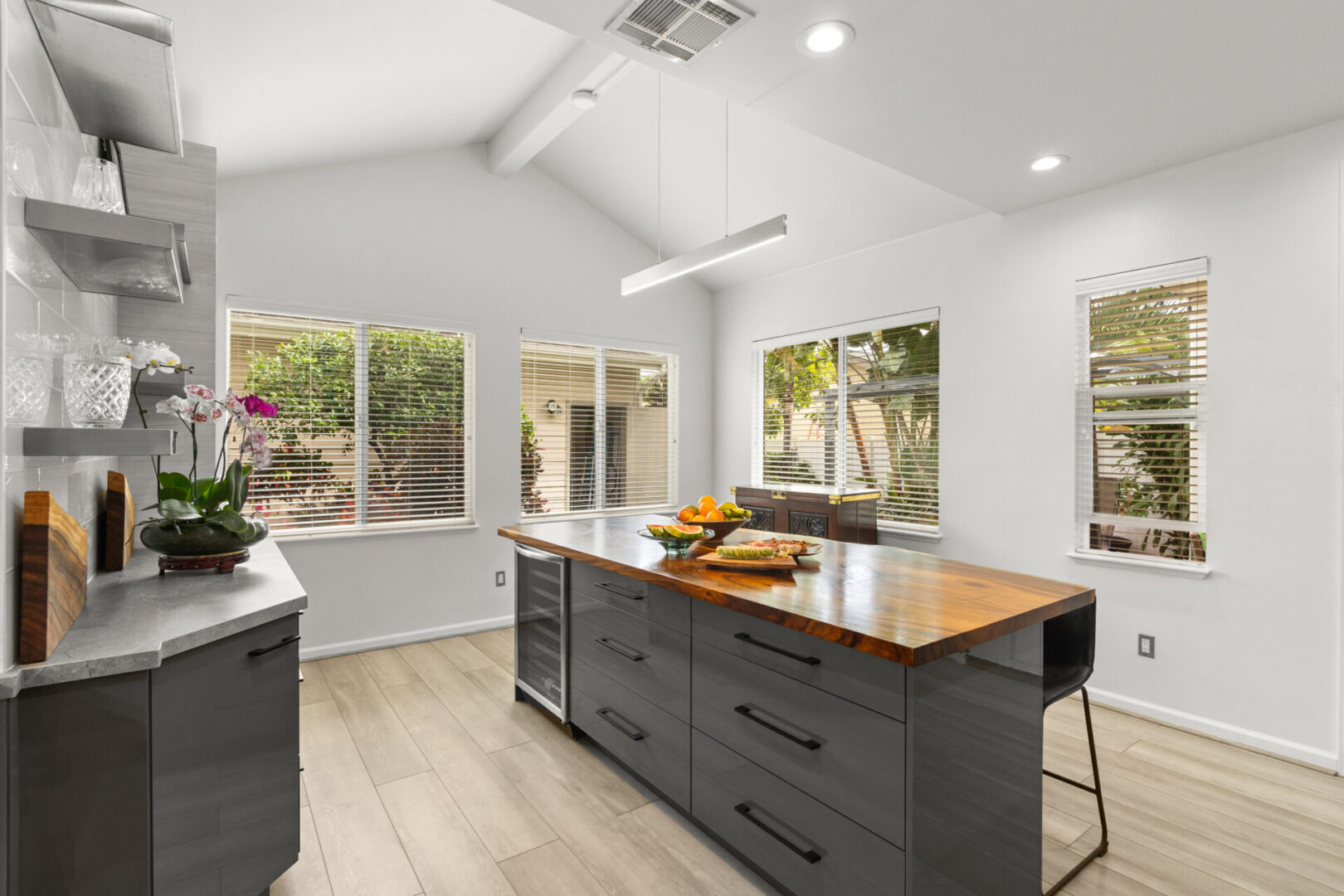 A kitchen with an island and wooden counter tops.