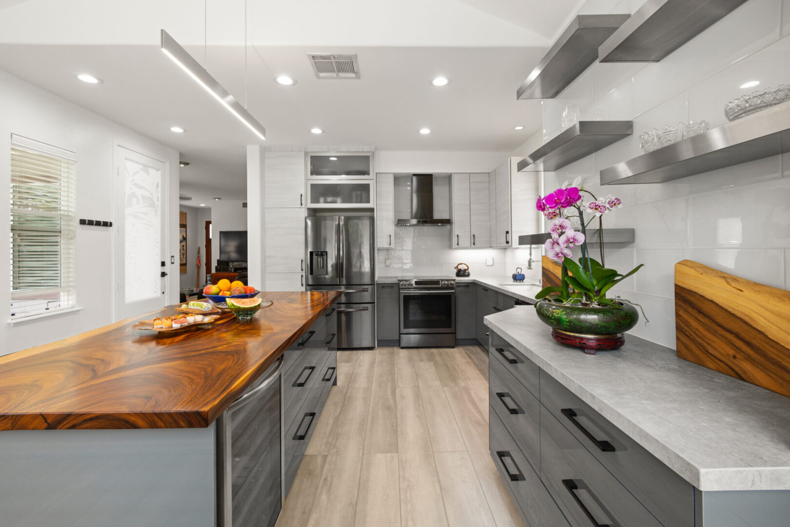 A kitchen with an island and wooden counter top.