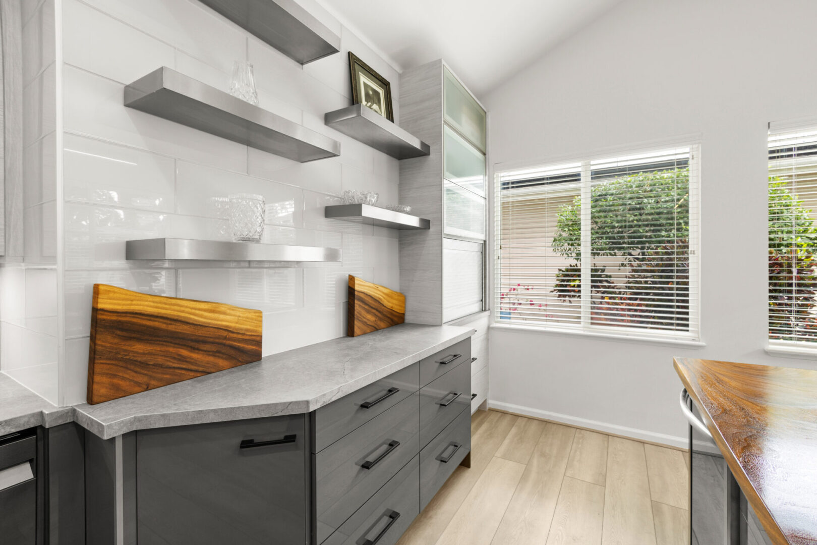 A kitchen with a window and wooden cabinets