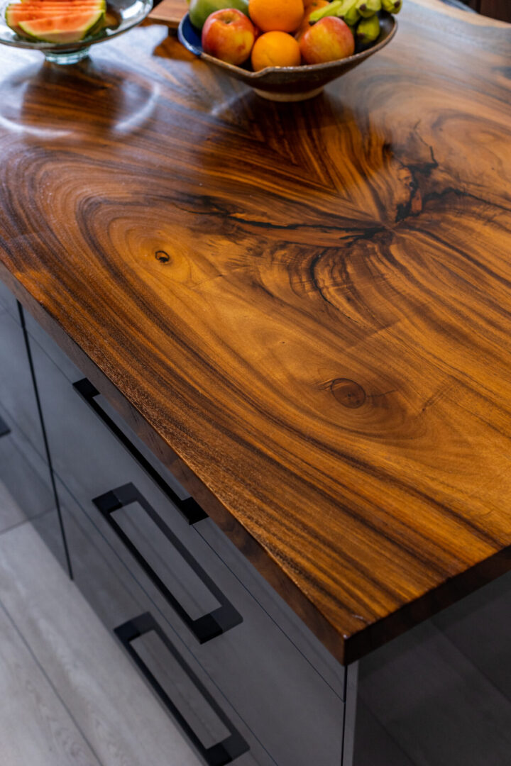 A wooden table with a black metal base.